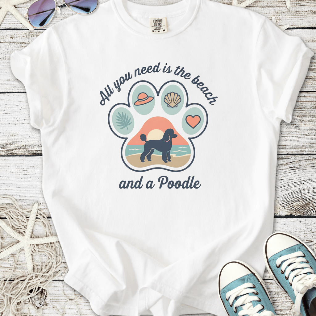 White t-shirt with a beach-themed graphic featuring a poodle and vibrant designs.