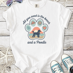 White t-shirt with a beach-themed graphic featuring a poodle and vibrant designs.