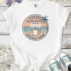 White graphic t-shirt featuring 'Coffee Tastes Better with an Ocean View' design, summer vibes.
