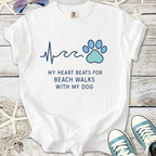 White graphic t-shirt with 'My heart beats for beach walks with my dog', featuring heart and paw prints.