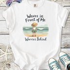 White t-shirt featuring a child with a straw hat, standing by the beach, text 'Waves in Front of Me'.