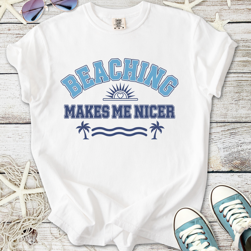 White t-shirt with 'Beaching Makes Me Nicer' graphic in blue and navy, perfect for summer outings.