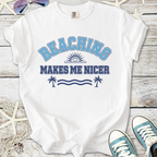 White t-shirt with 'Beaching Makes Me Nicer' graphic in blue and navy, perfect for summer outings.