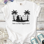 White t-shirt featuring a woman and dog silhouette with 'love is a four legged word' text, perfect for pet lovers.