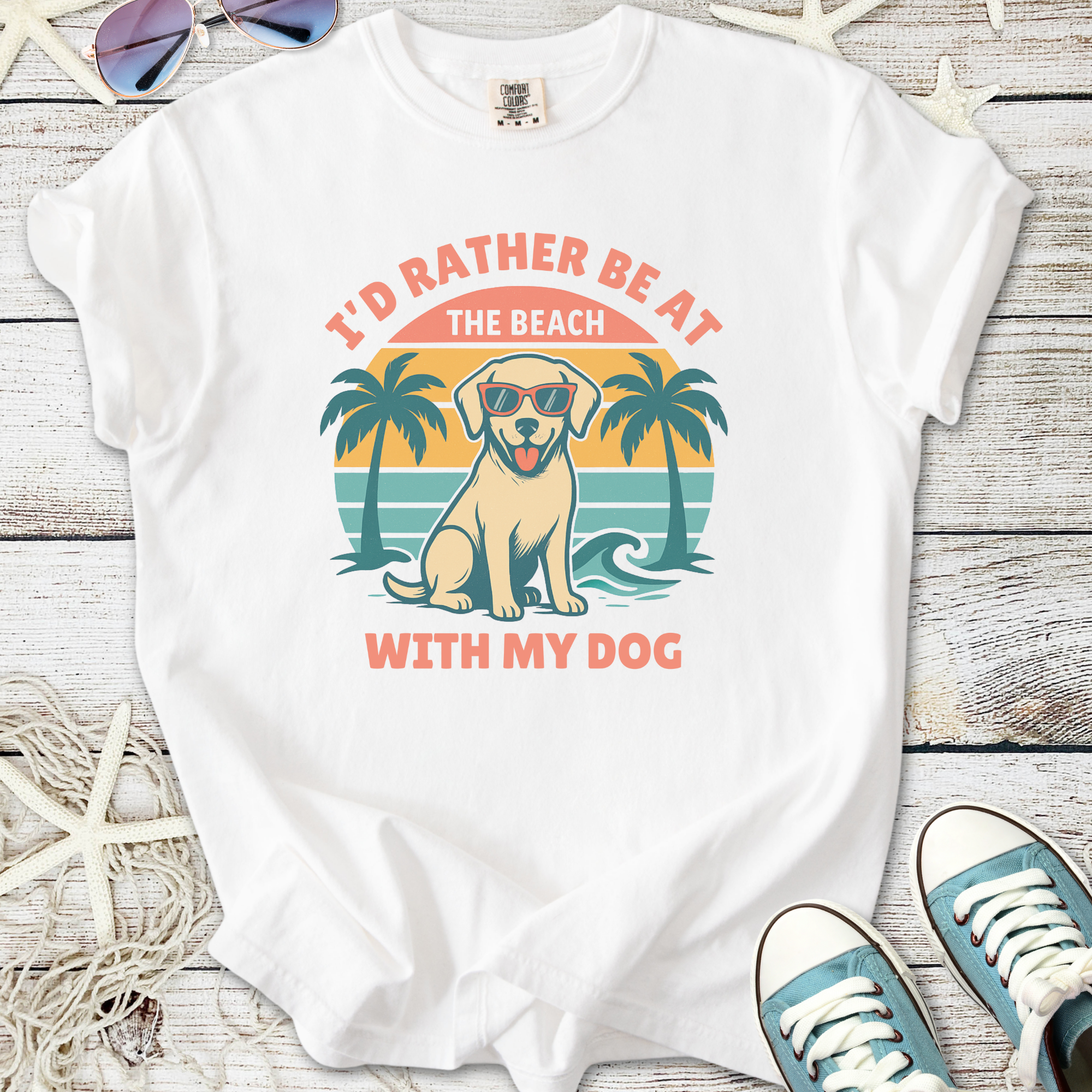 White t-shirt featuring a dog in sunglasses with beach graphic and text, perfect for dog and beach lovers.