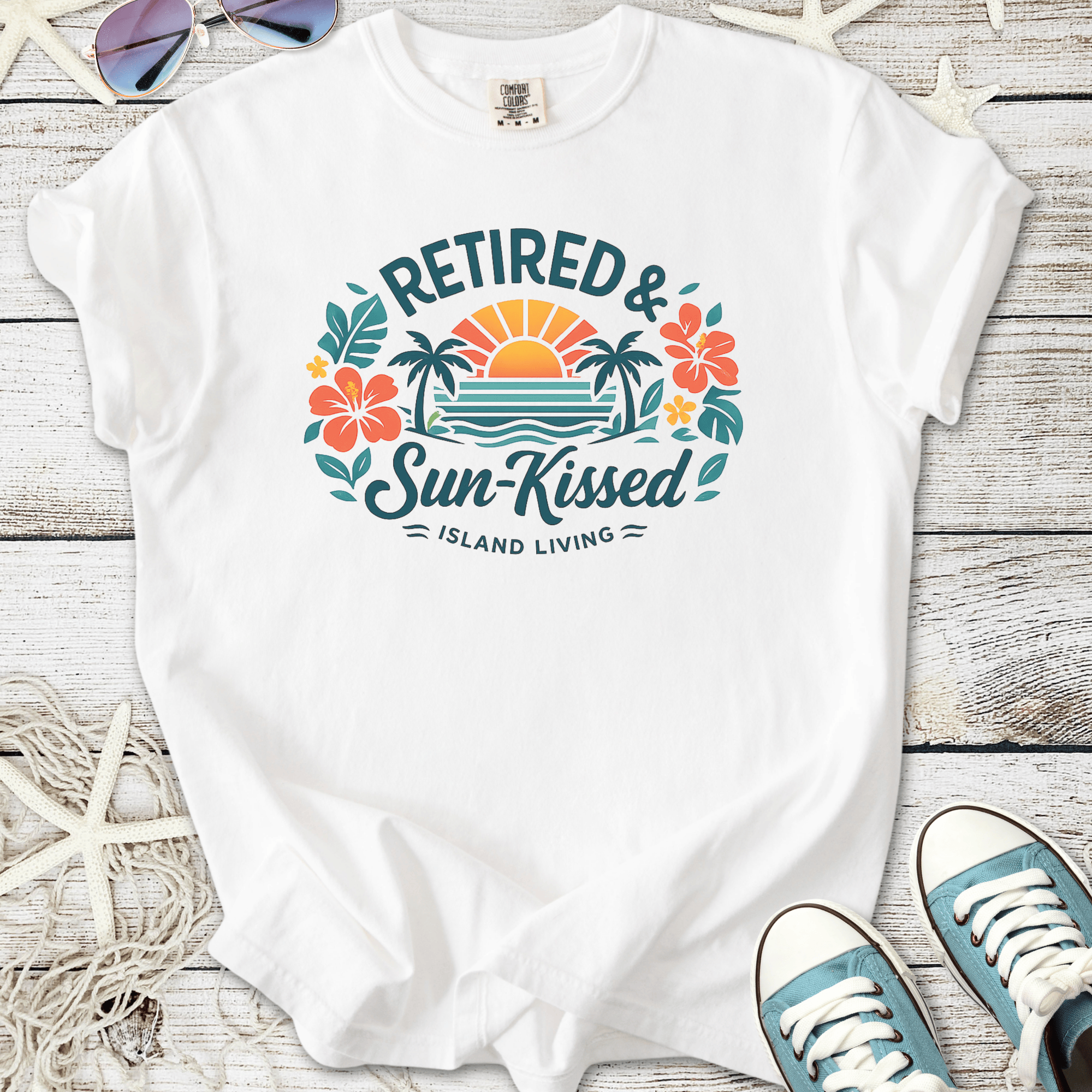 White t-shirt with 'Retired & Sun-Kissed' graphic, featuring tropical designs and vibrant colors.