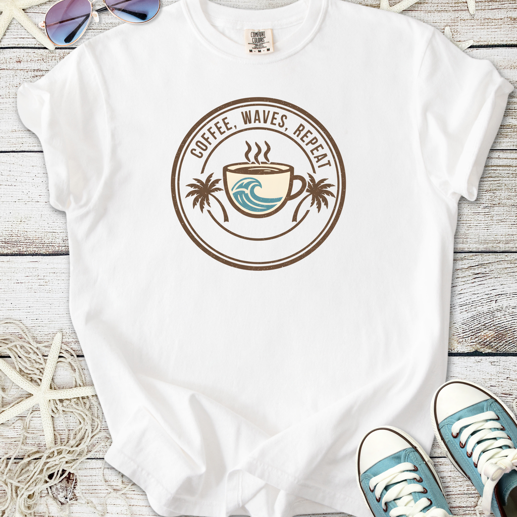 White graphic tee featuring 'Coffee, Waves, Repeat' design with a coffee cup and palm trees.