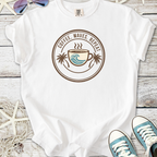 White graphic tee featuring 'Coffee, Waves, Repeat' design with a coffee cup and palm trees.