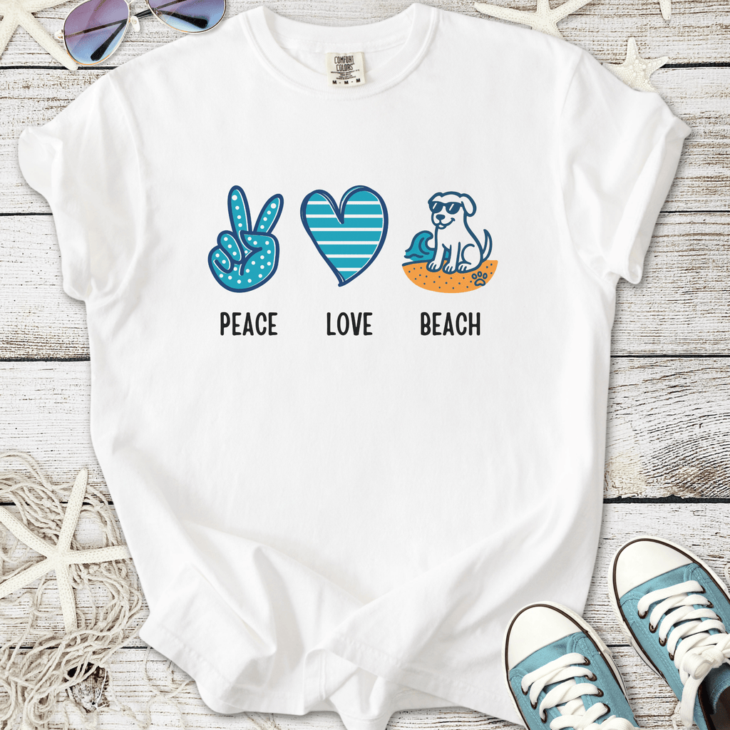 White t-shirt with 'Peace, Love, Beach' graphic featuring a dog, heart, and peace sign in blue and orange.
