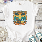 White t-shirt featuring 'Officially Retired' graphic with beach, palm trees, and sunset design.