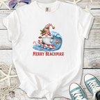 White t-shirt featuring a surfing Santa with the text 'Merry Beachmas!', perfect for holiday beachwear.