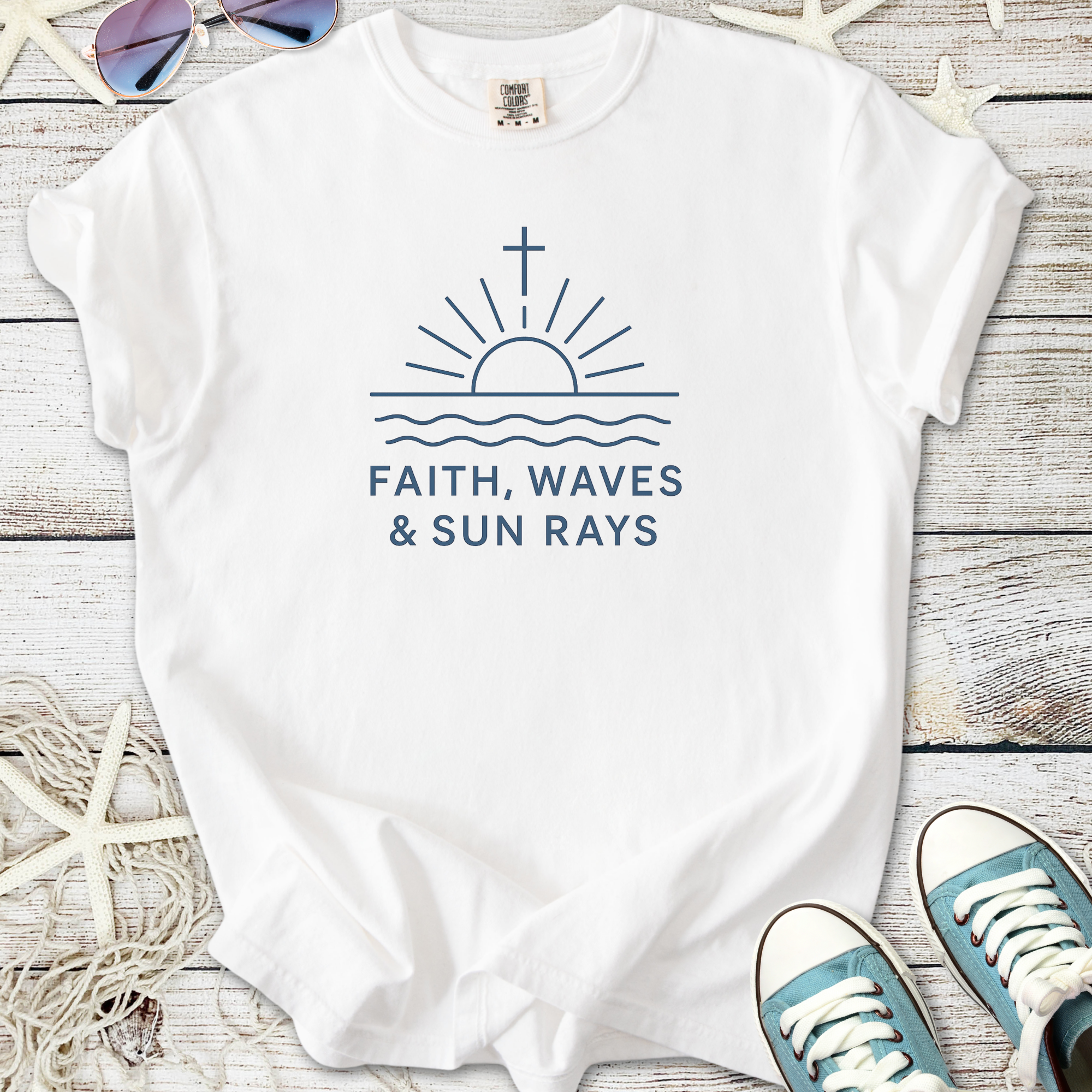 White graphic tee featuring sunrise with waves design and 'Faith, Waves & Sun Rays' text.