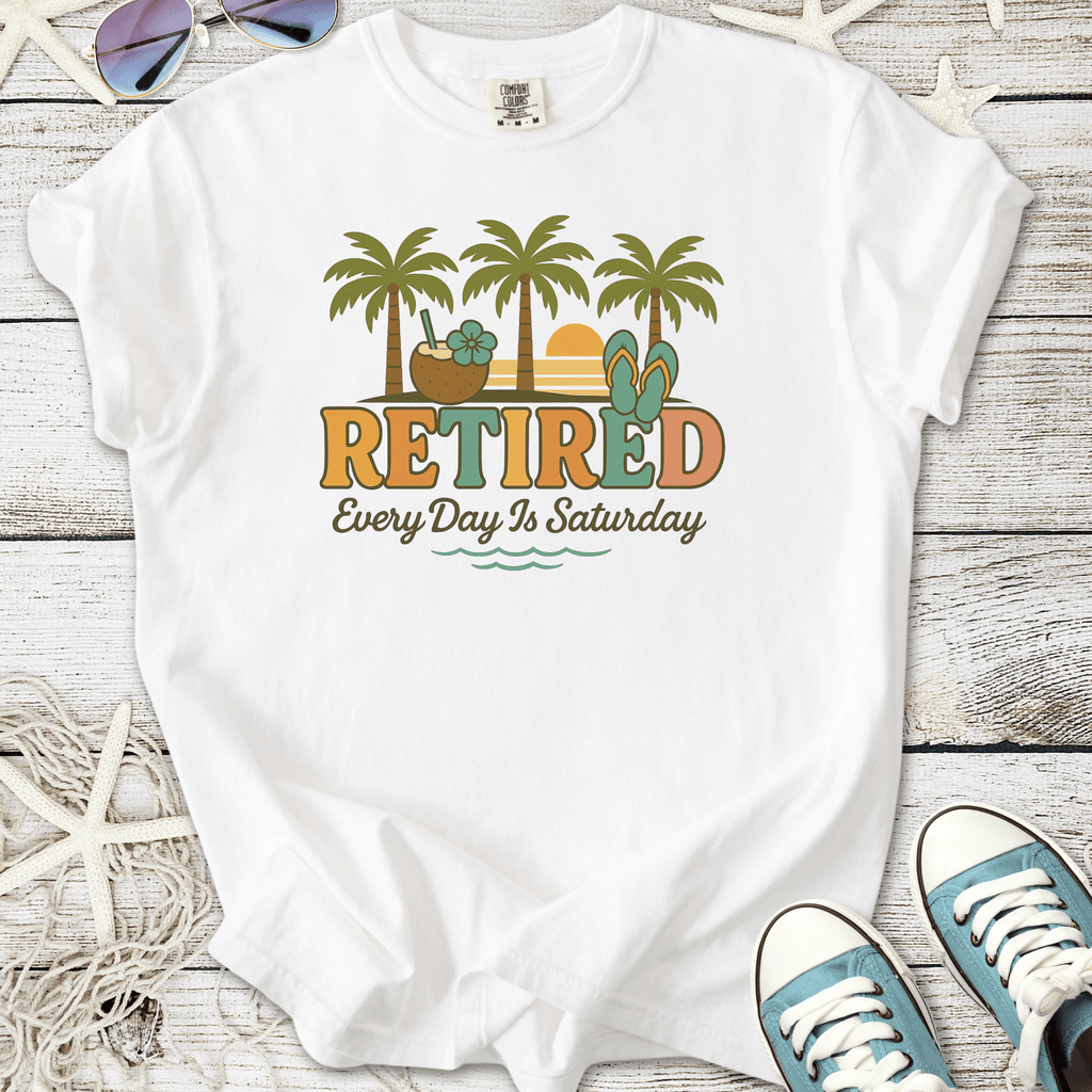 White t-shirt with 'Retired' graphic, palm trees, and sunset; perfect for relaxed, casual vibes.