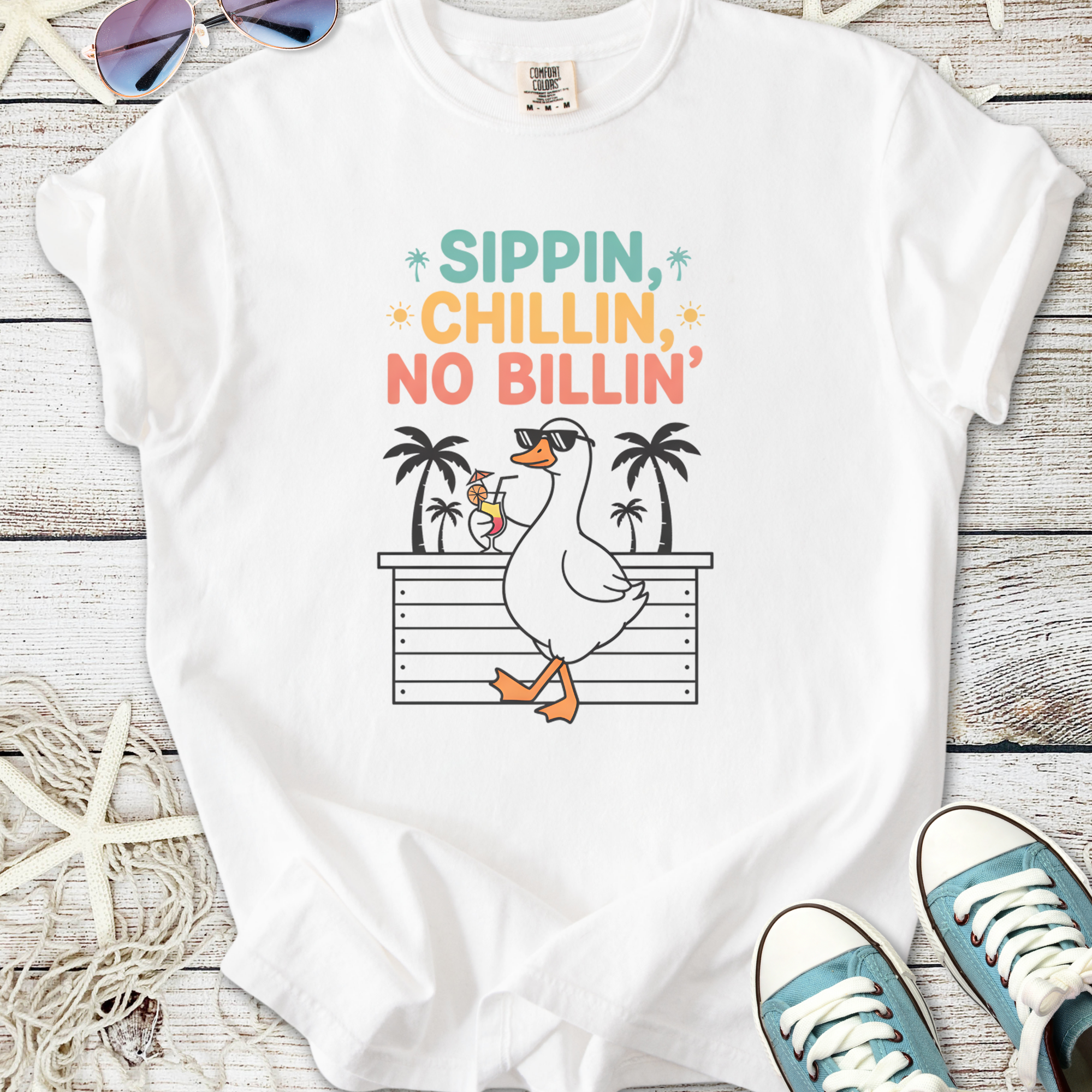 White graphic tee featuring a cartoon duck with sunglasses and cocktail, text "Sippin, Chillin, No Billin'".