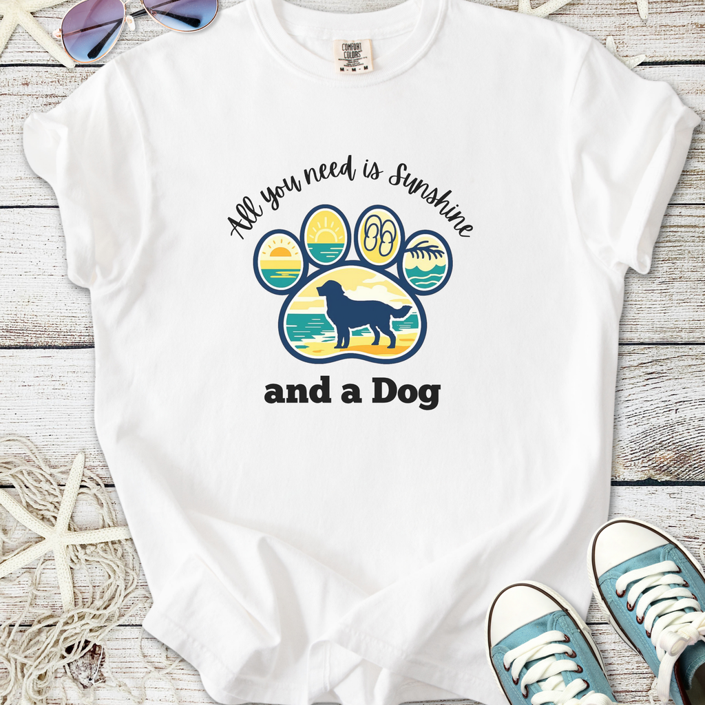 White t-shirt featuring a colorful dog paw graphic with the phrase 'All you need is Sunshine and a Dog'