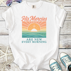 White graphic t-shirt featuring sunrise design with text 'His Mercies Are New Every Morning'.
