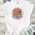 White t-shirt with 'Salt in the Air, Peace in My Soul' graphic, featuring sunset and beach scene