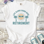 White cotton t-shirt with 'Life Slows Down Here' retirement graphic and palm trees.