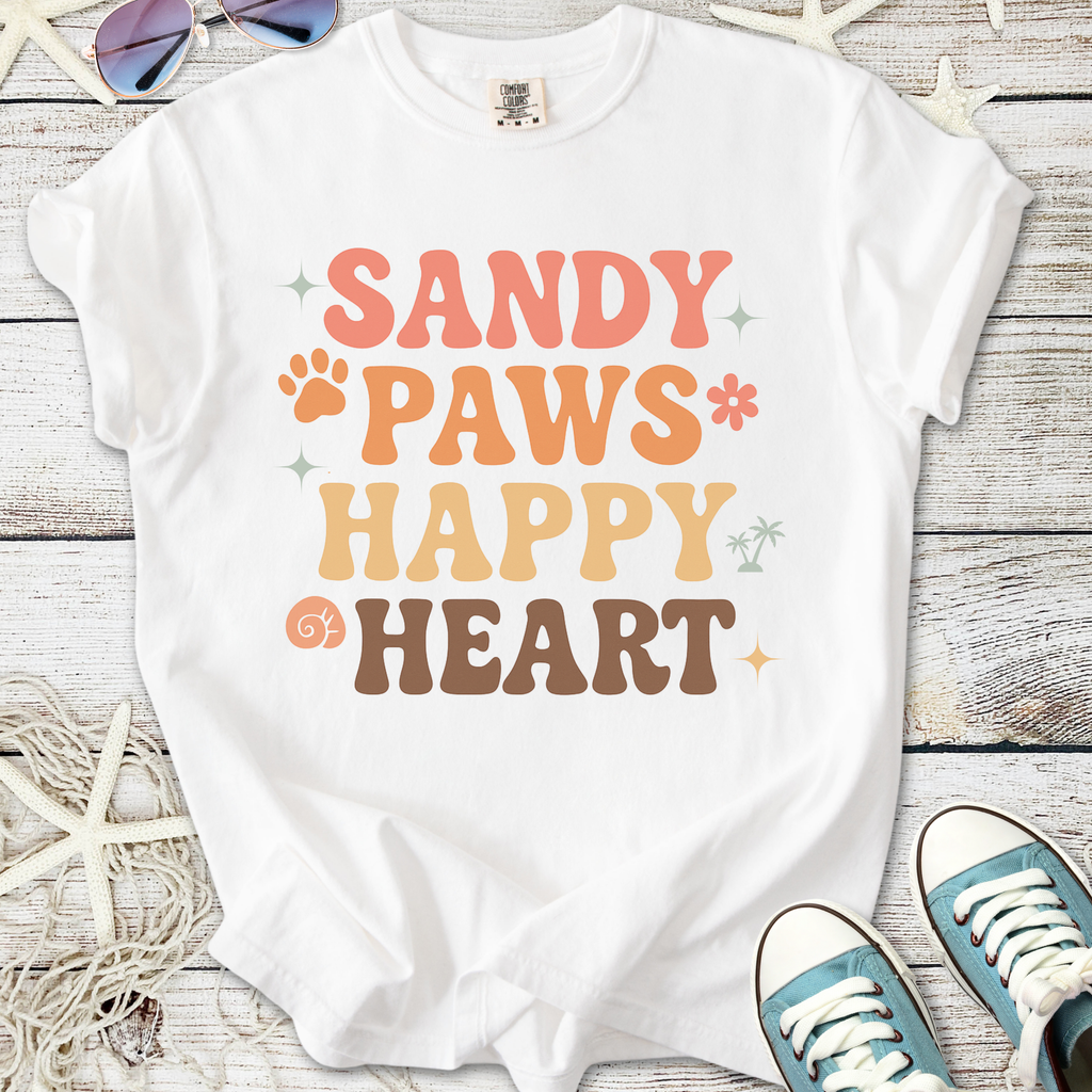 White t-shirt with colorful 'Sandy Paws Happy Heart' graphic, perfect for casual beach outings.
