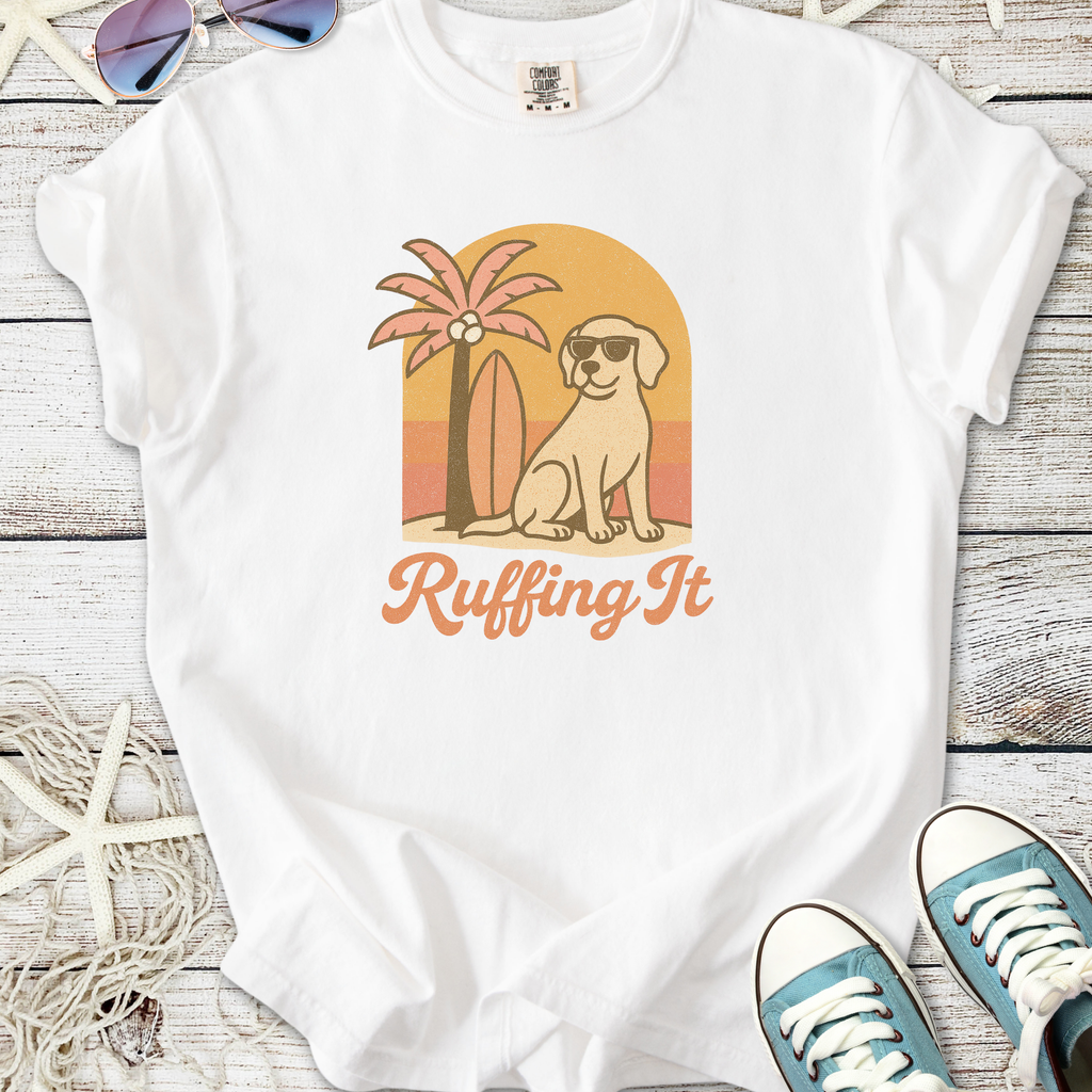 White t-shirt with 'Ruffing It' graphic, featuring a dog, palm tree, and surfboard design.