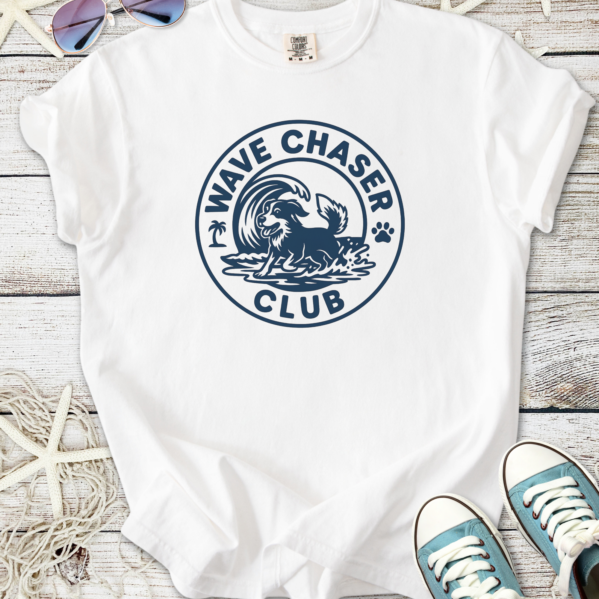 White t-shirt featuring a navy wave chaser dog club graphic. Perfect for beach lovers and dog owners.