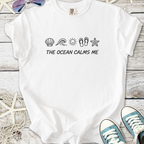 White t-shirt with 'THE OCEAN CALMS ME' and ocean-themed icons, perfect for beach lovers.