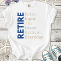 White t-shirt with 'RETIRE' graphic, featuring relaxed island-themed text in blue and pastel colors.
