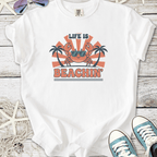 White graphic t-shirt featuring a crab, sunglasses, and text 'Life is Beachin' with palm trees.