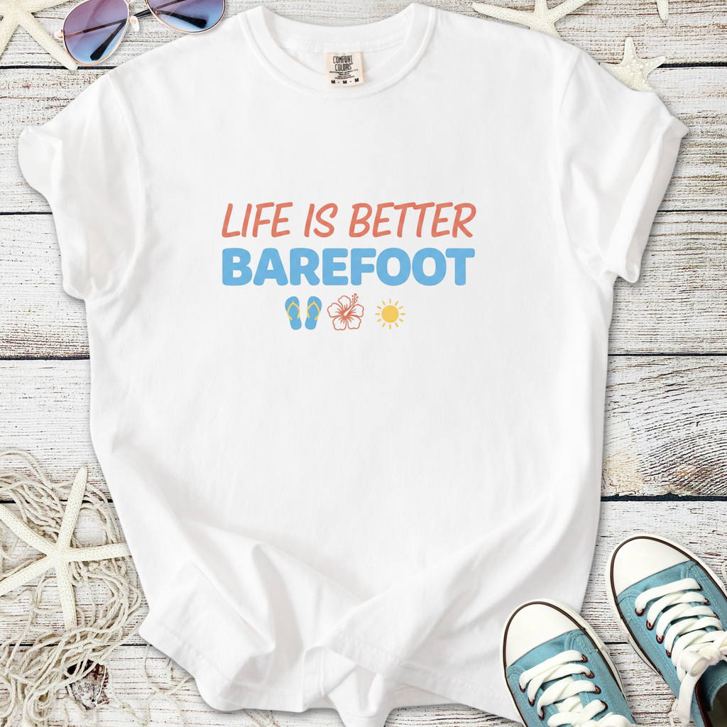 White t-shirt with 'Life Is Better Barefoot' graphic, featuring flip-flops, a flower, and sun emojis.