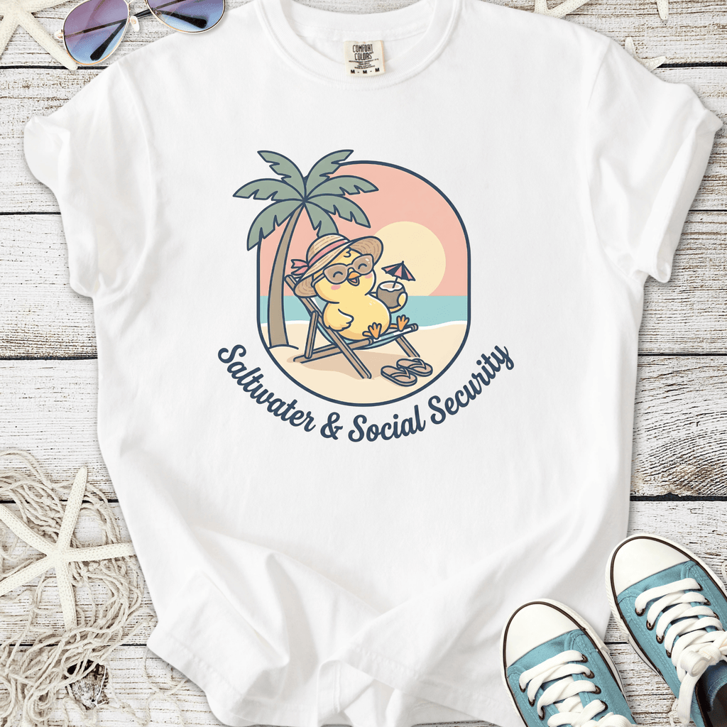 White t-shirt featuring playful sunbathing character with palm trees, captioned 'Saltwater & Social Security'.
