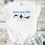 White cotton t-shirt featuring 'Ocean Lover Club' graphic with dolphins and manta ray design.