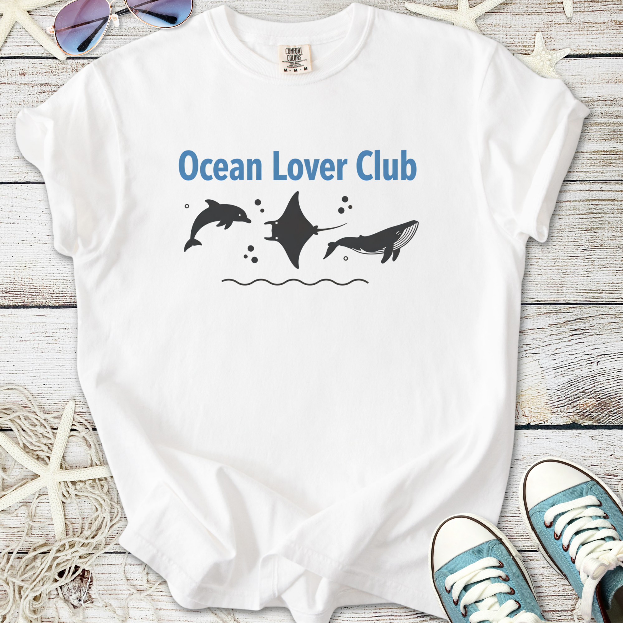 White cotton t-shirt featuring 'Ocean Lover Club' graphic with dolphins and manta ray design.