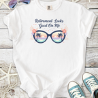 White t-shirt with 'Retirement Looks Good On Me' graphic and sunglasses design, perfect for retirees.