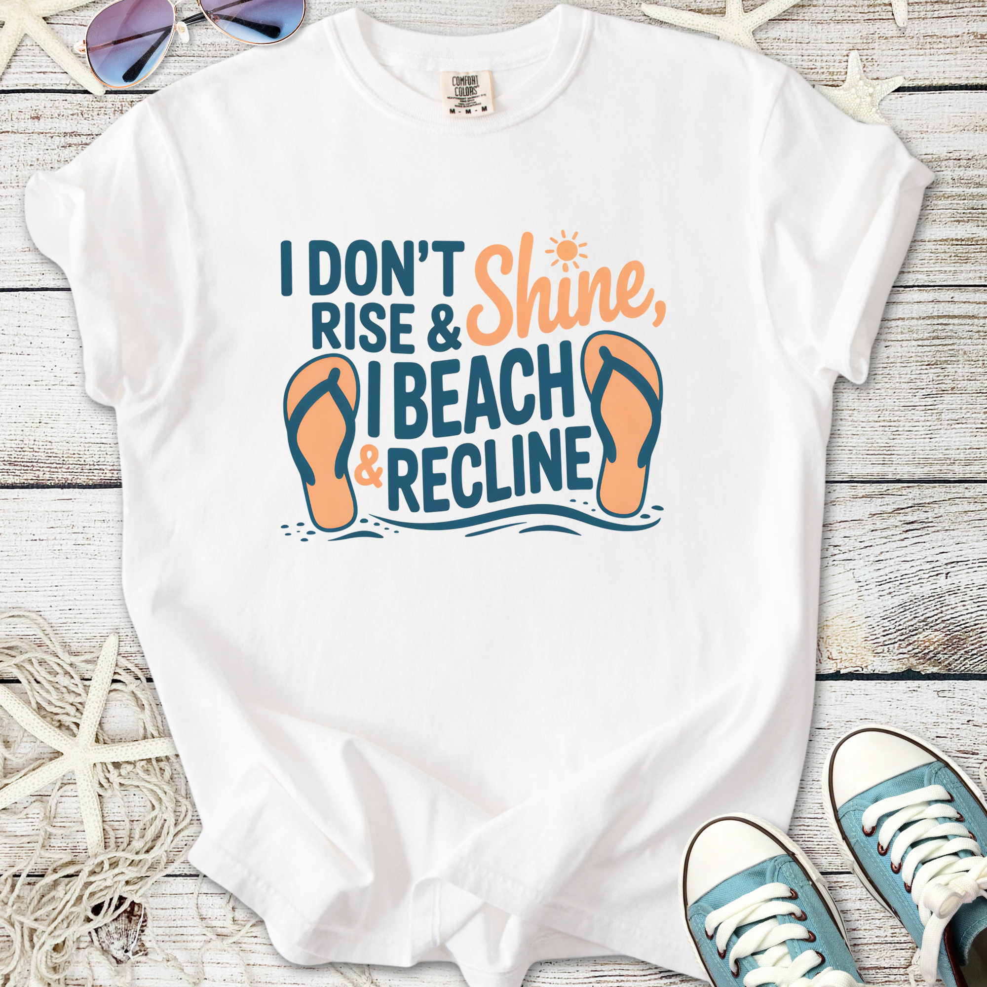 White graphic tee with beach theme, featuring 'I Beach & Recline' text and flip-flops design.