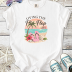 White t-shirt with 'Living the Flip Flop Life' graphic, featuring pink flip flops, beach theme, and casual style.