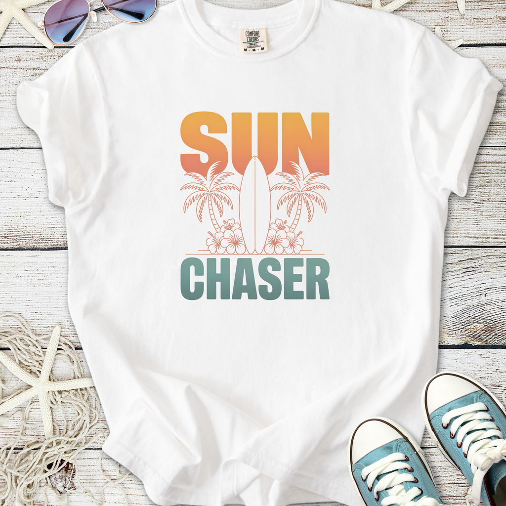 White cotton t-shirt with 'SUN CHASER' graphic, featuring palm trees and a surfboard, perfect for summer vibes.