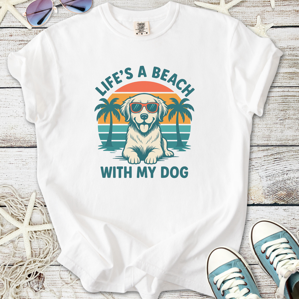 White t-shirt featuring a dog in sunglasses with beach and palm trees design.