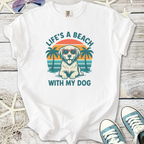 White t-shirt featuring a dog in sunglasses with beach and palm trees design.