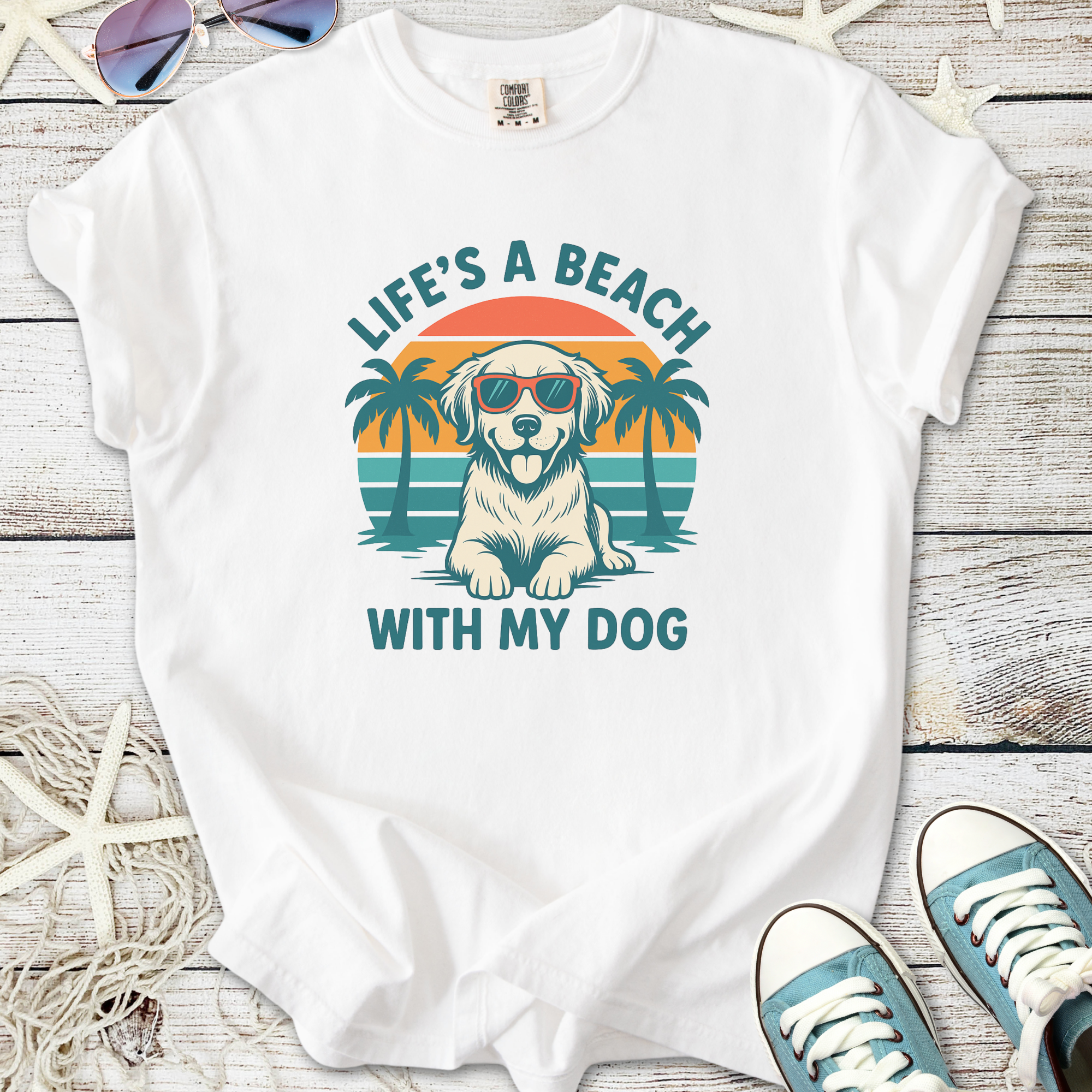 White t-shirt featuring a dog in sunglasses with beach and palm trees design.