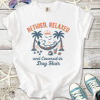 White t-shirt featuring 'Retired, Relaxed, and Covered in Dog Hair' graphic with a dog in a hammock.