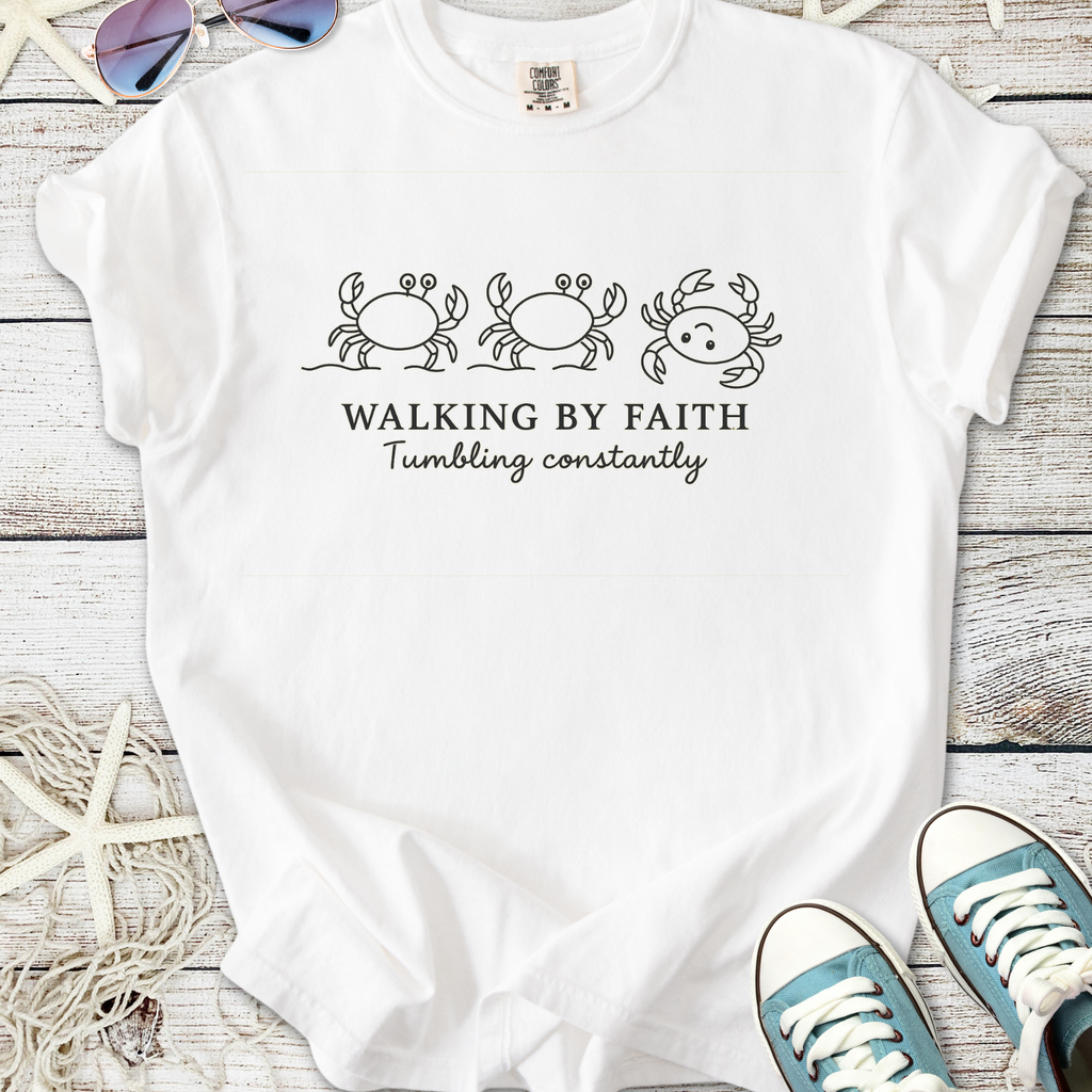 White t-shirt with crab illustrations and 'Walking By Faith, Tumbling Constantly' text design.