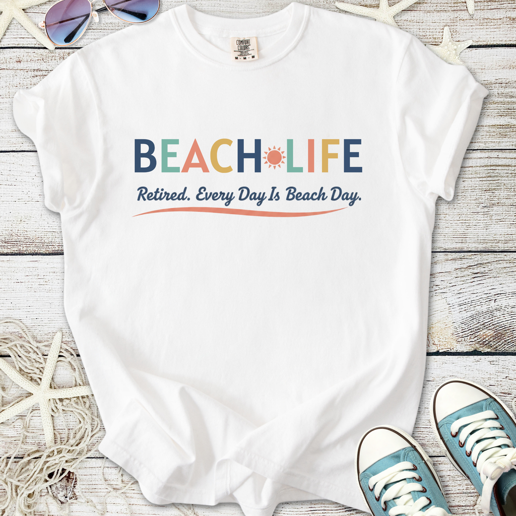 White cotton t-shirt with 'BEACH LIFE' graphic, perfect for retired beach lovers.