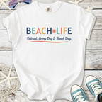 White cotton t-shirt with 'BEACH LIFE' graphic, perfect for retired beach lovers.