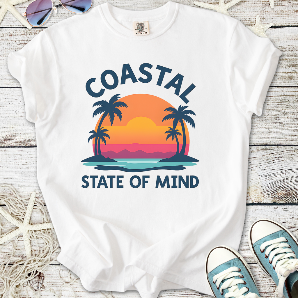 White t-shirt with 'Coastal State of Mind' graphic, featuring palm trees and sunset design.