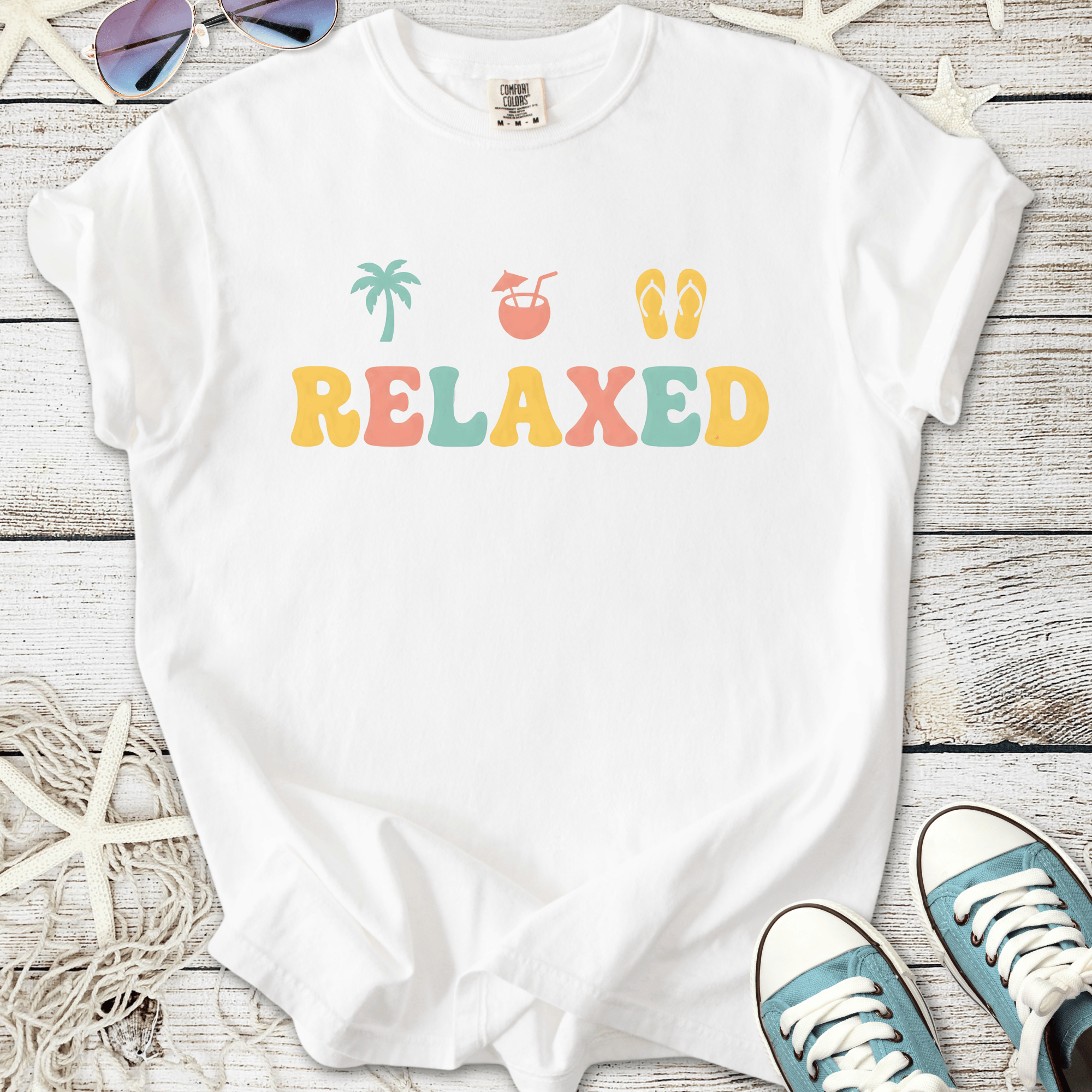 White relaxed graphic t-shirt with vibrant colors and tropical theme, perfect for casual summer wear.