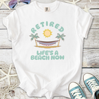 White cotton t-shirt with 'Retired, Life's a Beach Now' graphic featuring sun and palm trees.