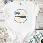 White t-shirt featuring a beach graphic and text 'Collecting Memories One Beach Day at a Time'