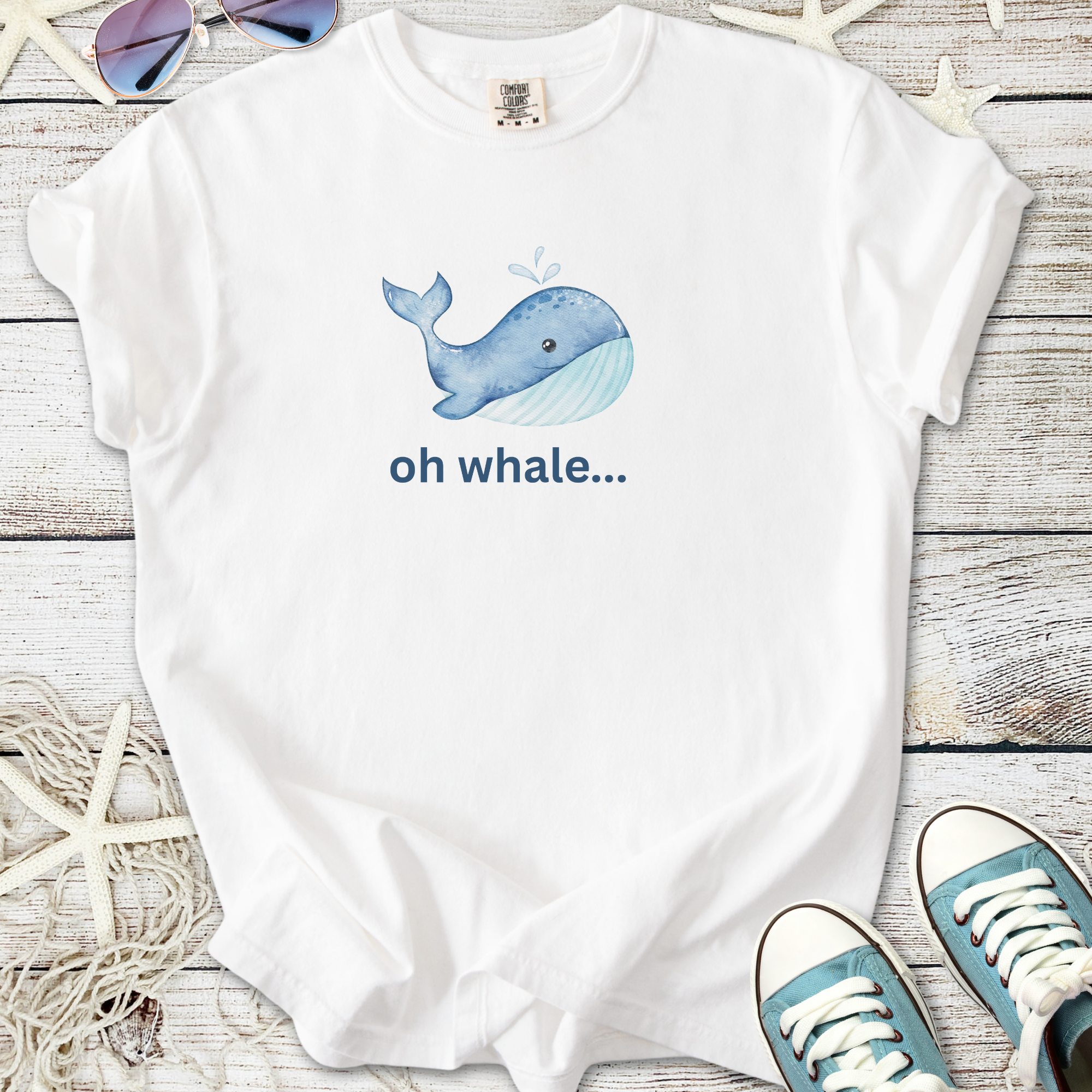 White unisex t-shirt featuring a cute whale graphic and text 'oh whale...' perfect for casual summer wear.