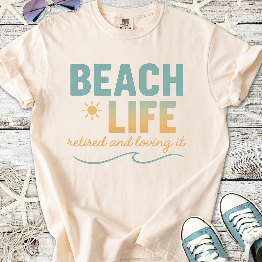 Cream beach-themed t-shirt with 'Beach Life' graphic, perfect for retirees who love the ocean.