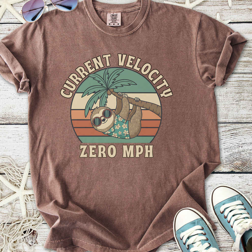 Brown graphic t-shirt featuring a sloth, palm tree, and 'Current Velocity Zero MPH' print.